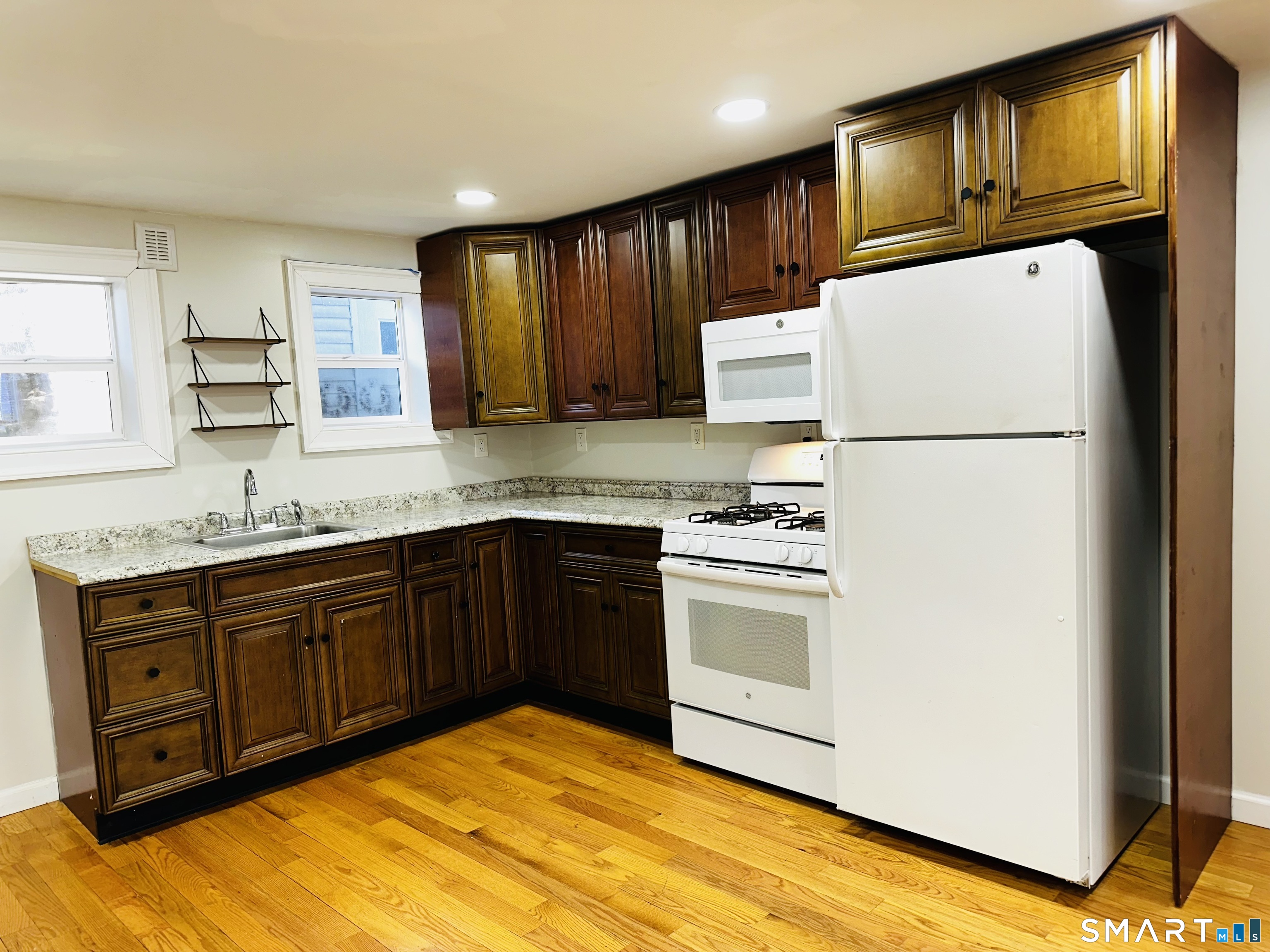 a kitchen with stainless steel appliances granite countertop a refrigerator sink and cabinets
