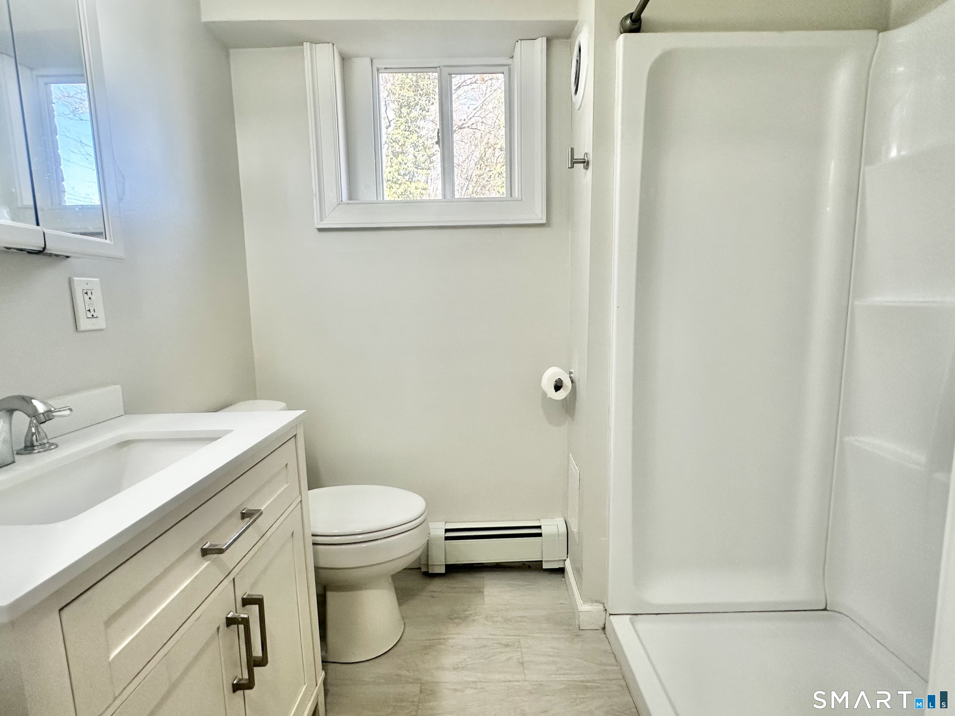 49 Pleasant Street Ansonia, CT 06401 - Photo 15 of 17 a bathroom with a granite countertop toilet a sink and a mirror