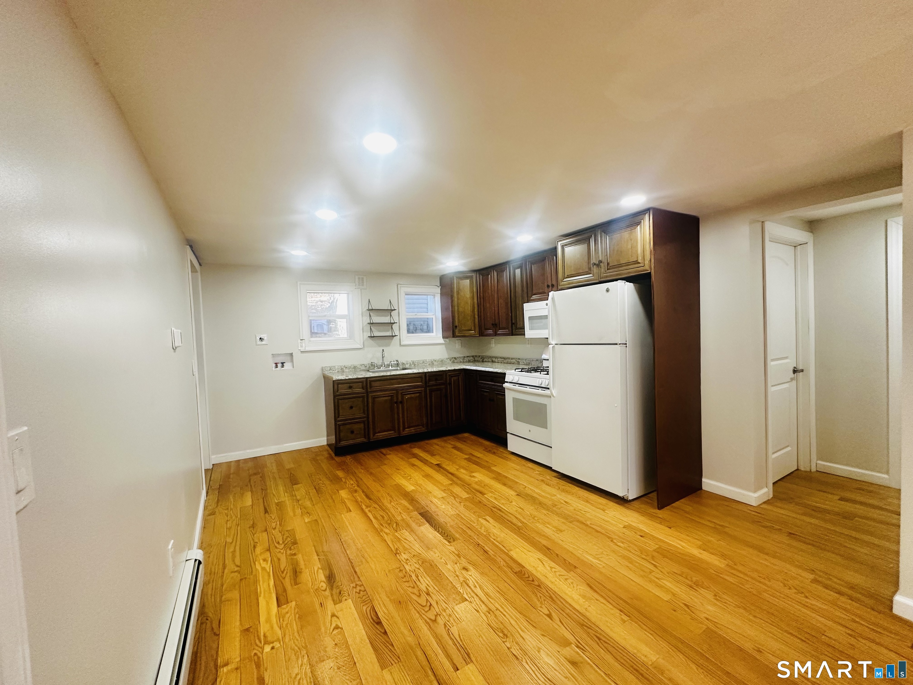 49 Pleasant Street Ansonia, CT 06401 - Photo 2 of 17 a view of a kitchen with refrigerator and white cabinets