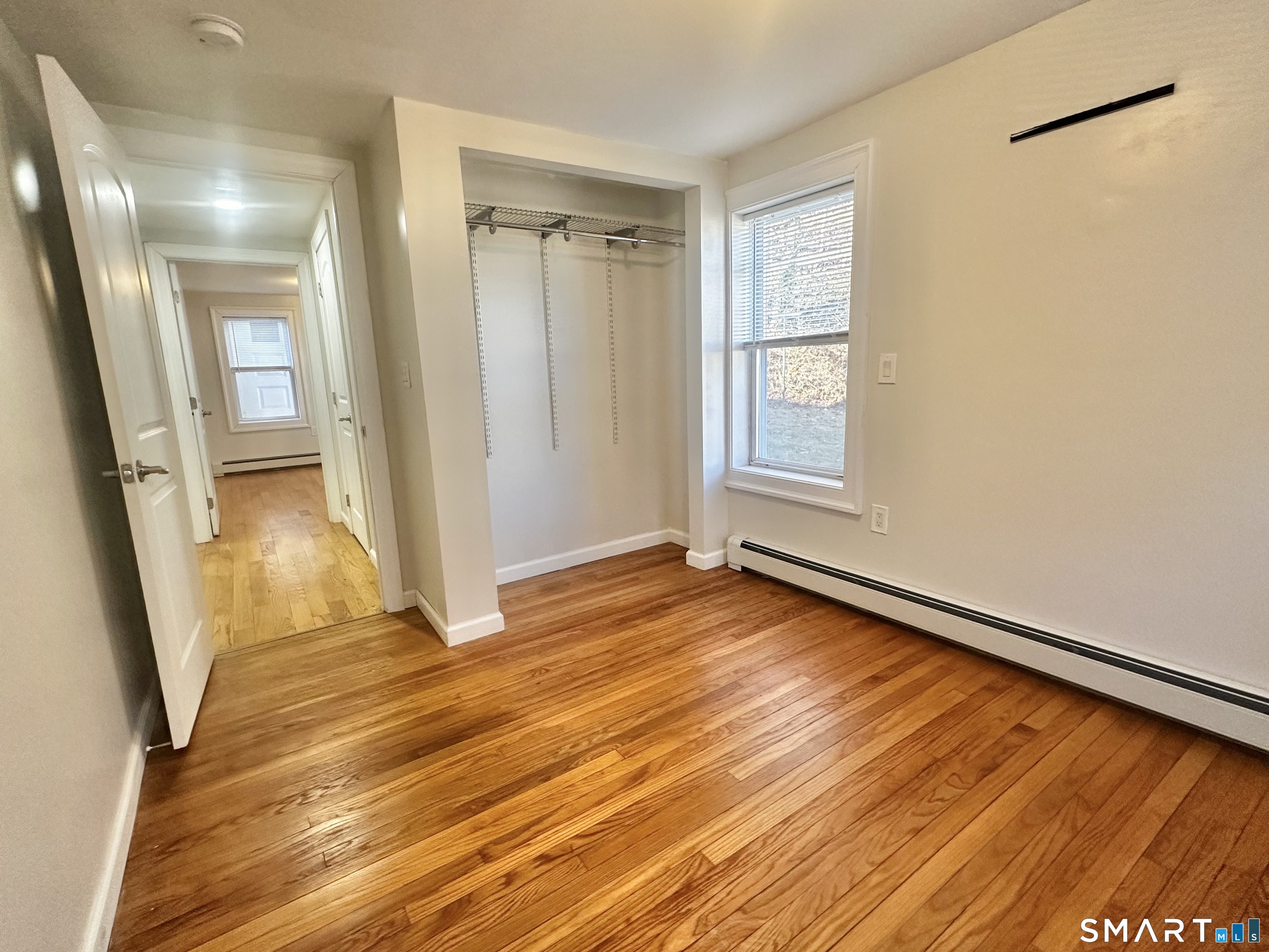 49 Pleasant Street Ansonia, CT 06401 - Photo 10 of 17 a view of an empty room with wooden floor and a window