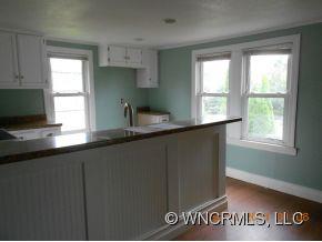200 Pigeon Road Canton, NC 28716 - Photo 7 of 17 a kitchen with granite countertop a sink window and cabinets