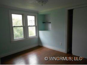 200 Pigeon Road Canton, NC 28716 - Photo 9 of 17 an empty room with wooden floor and windows