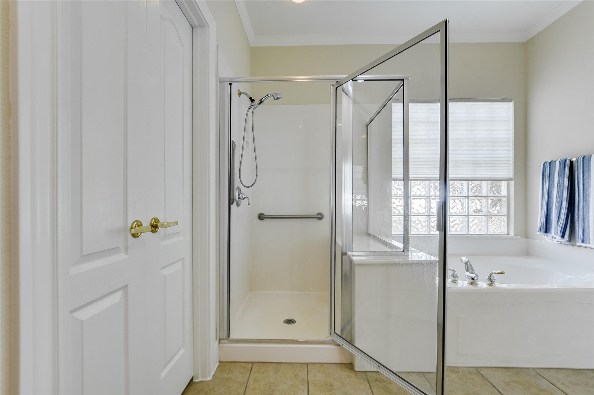 603 Rio Grande Loop Georgetown, TX 78633 - Photo 18 of 27 Full bath featuring a stall shower, ornamental molding, a bath, and light tile patterned floors