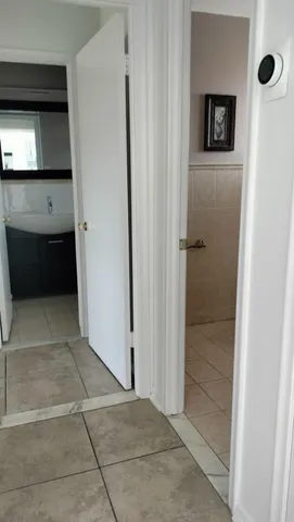 a kitchen with white cabinets and appliances