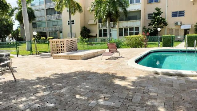 a front view of a building with a garden