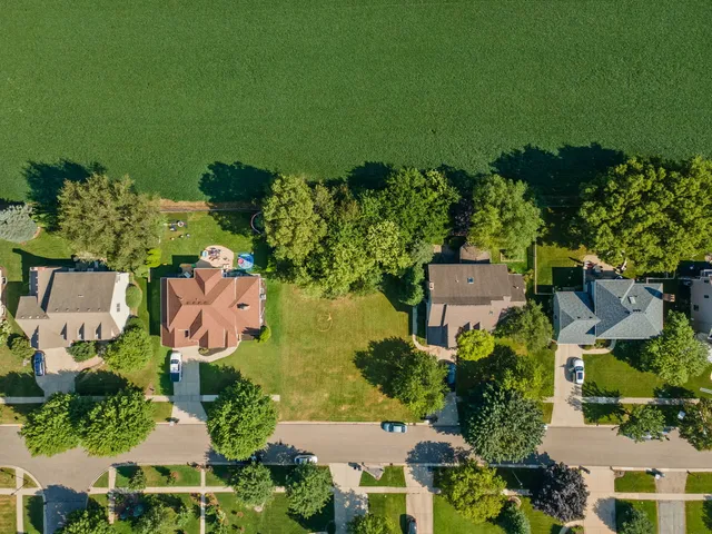 an aerial view of a house with a yard