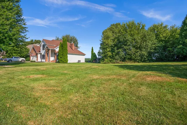a view of a field of grass and trees