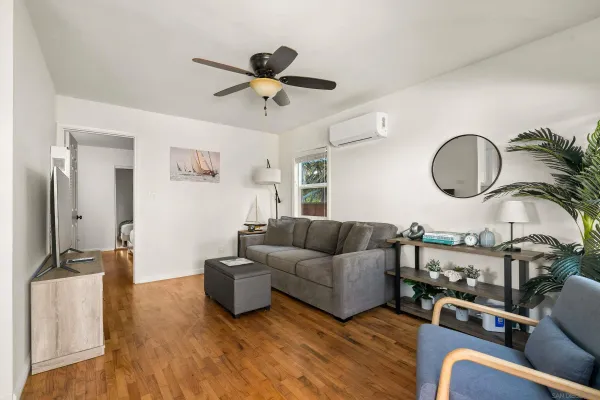 a living room with furniture and a large mirror