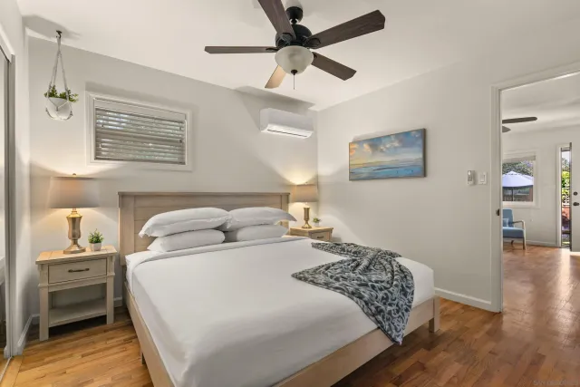 a bedroom with a bed and a ceiling fan