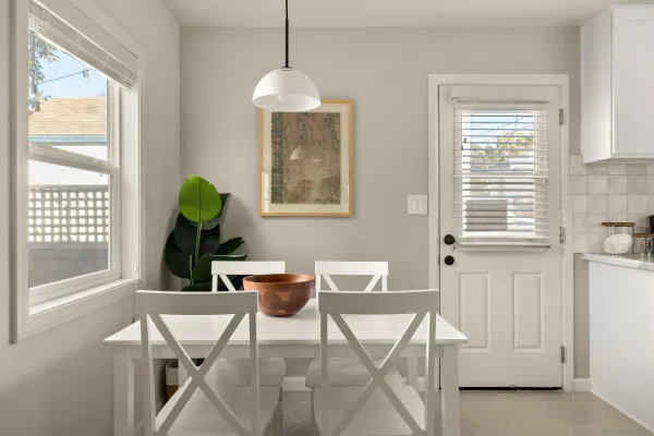 a view of a dining room that has a table and chairs in it