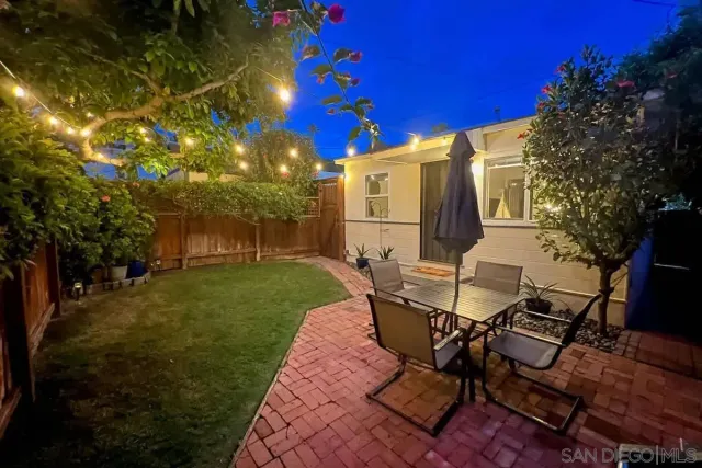 a view of a patio with table and chairs and potted plants