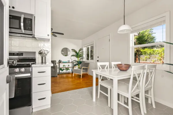 a kitchen with a table chairs and a stove