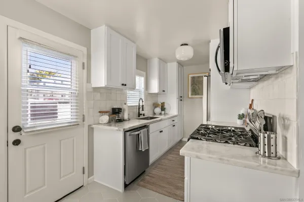 a kitchen with stainless steel appliances granite countertop a stove and a sink