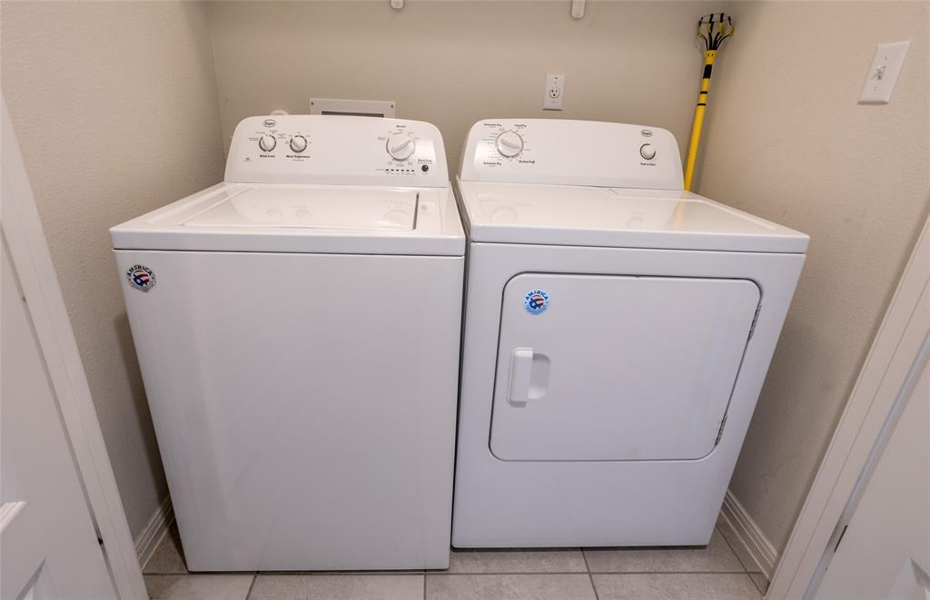 615 Stampede Road San Marcos, TX 78666 - Photo 13 of 26 Functional laundry nook with washer and dryer, providing essential utility.
