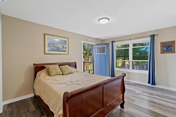 a bed sitting in a bedroom next to a window