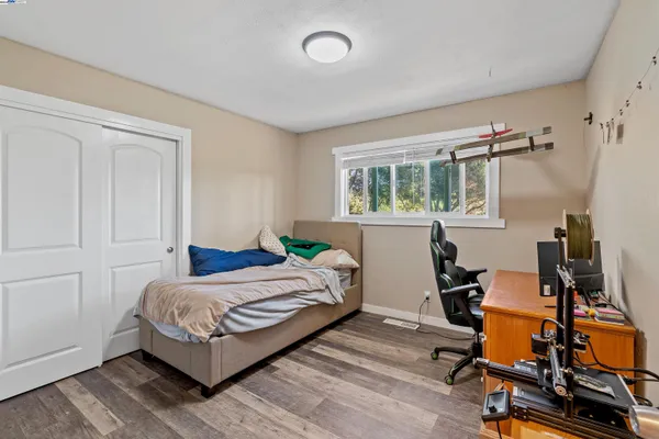 a bathroom with a granite countertop sink a toilet and a mirror