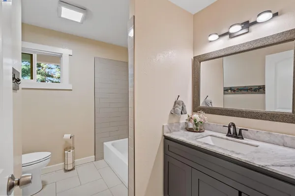 a bathroom with a shower sink and mirror
