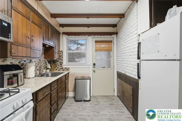 a kitchen with stainless steel appliances a sink stove and cabinets