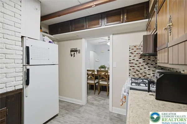 a kitchen with stainless steel appliances granite countertop a refrigerator and a stove