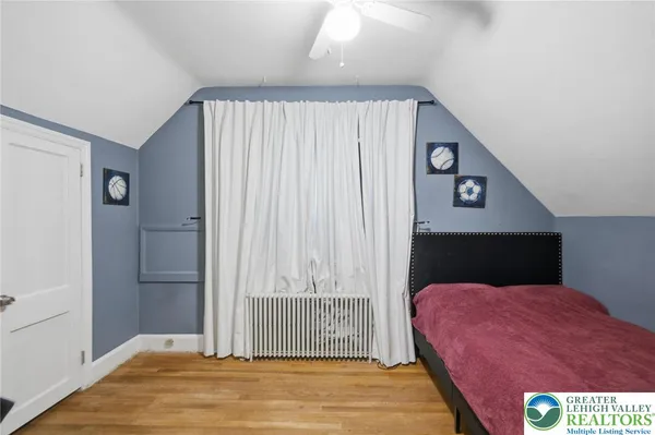 a spacious bedroom with a bed and a window