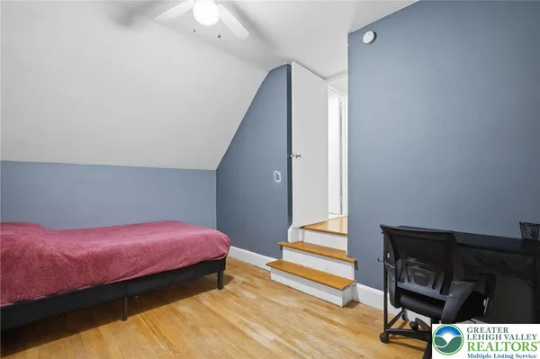 a bedroom with a bed and a workspace