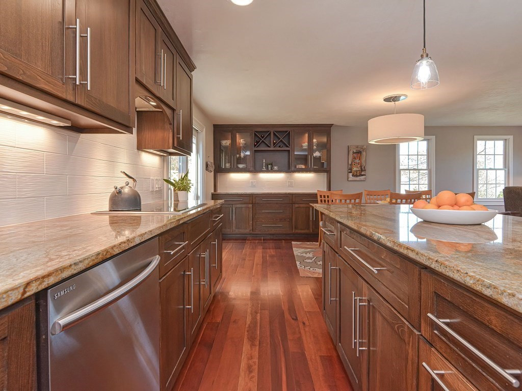 89 McClellan Road Sutton, MA 01590 - Photo 11 of 42 a large kitchen with kitchen island granite countertop a sink and wooden cabinets