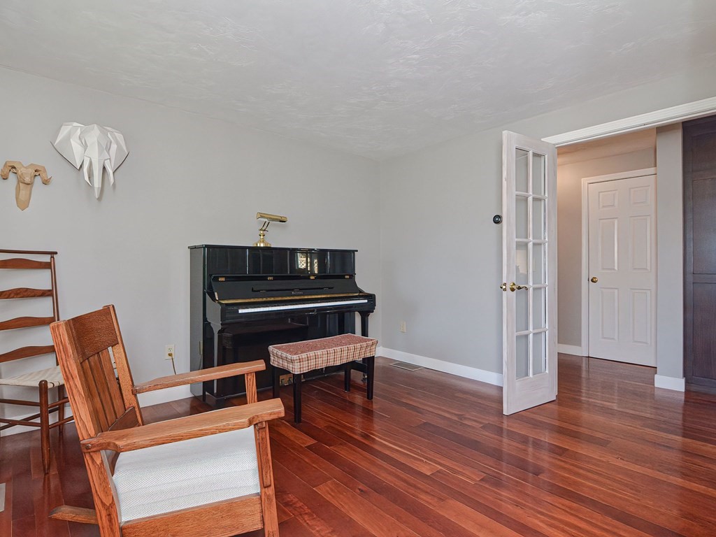 89 McClellan Road Sutton, MA 01590 - Photo 18 of 42 a living room with furniture a piano and wooden floor