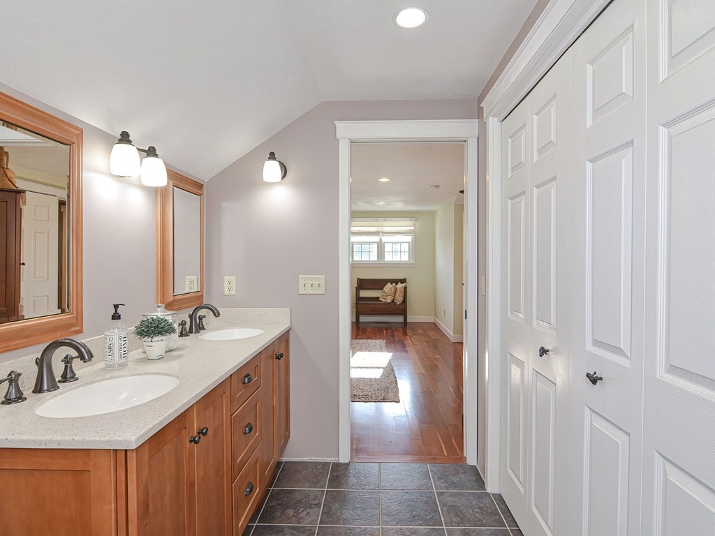 89 McClellan Road Sutton, MA 01590 - Photo 26 of 42 a bathroom with a double vanity sink and a mirror