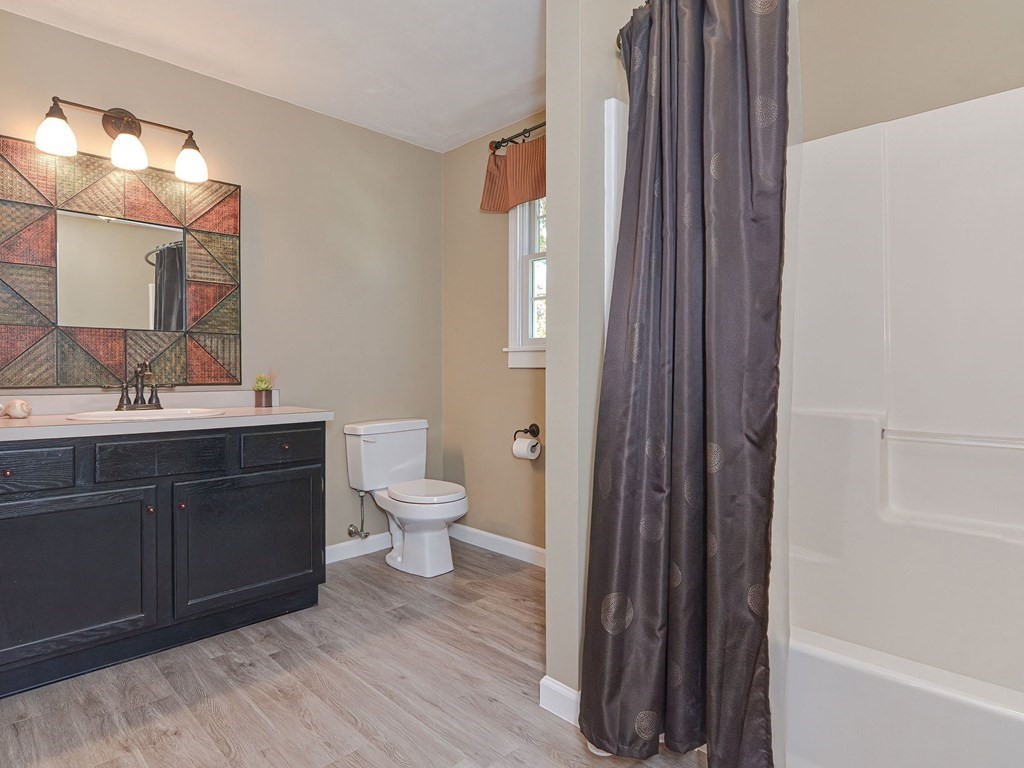 89 McClellan Road Sutton, MA 01590 - Photo 35 of 42 a bathroom with a sink and a mirror