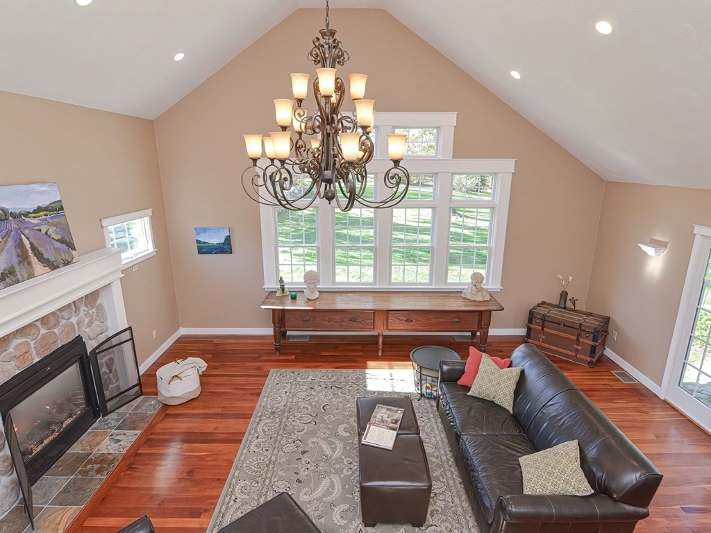 89 McClellan Road Sutton, MA 01590 - Photo 9 of 42 a living room with furniture and a chandelier