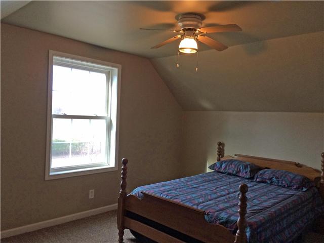 5729 Hopewell Road Springfield, TN 37172 - Photo 10 of 12 a bedroom with a bed and a chandelier