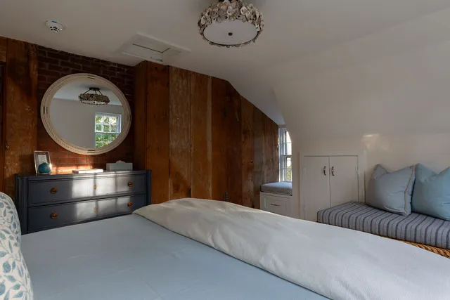 a large bed sitting in a bedroom next to a window