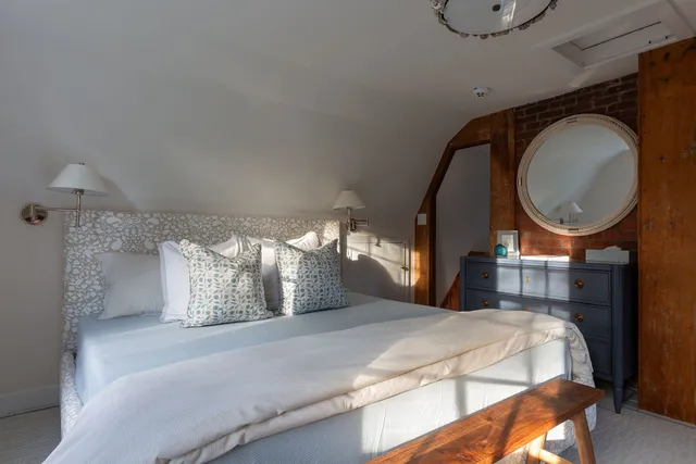 a bathroom with a granite countertop sink a mirror and shower