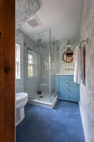 a bathroom with a toilet sink and shower
