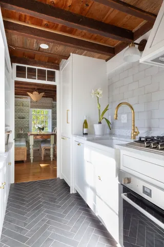 a kitchen with a refrigerator and a stove top oven