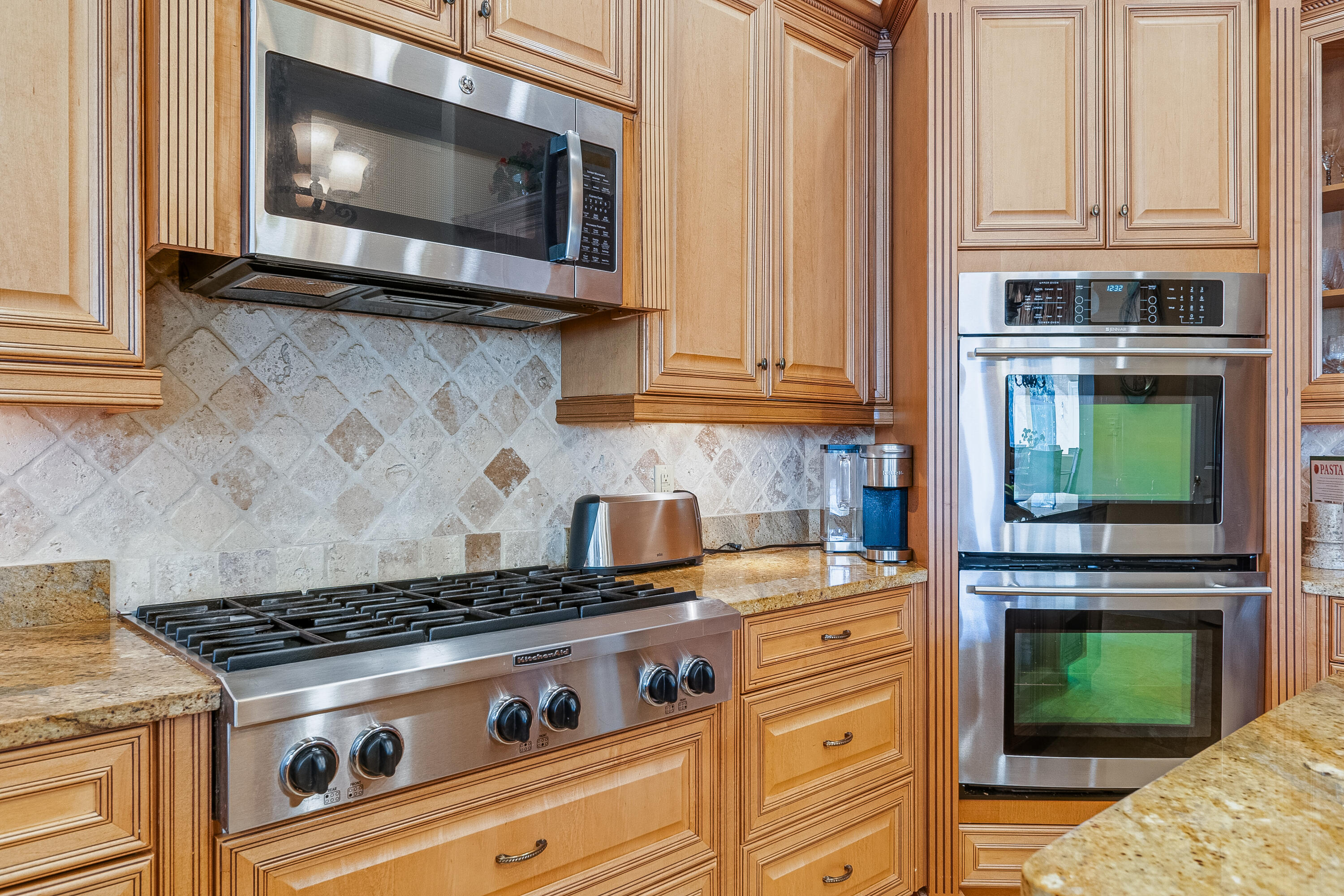 473 Captains Circle Destin, FL 32541 - Photo 26 of 64 a kitchen with granite countertop cabinets stainless steel appliances and a wooden floor