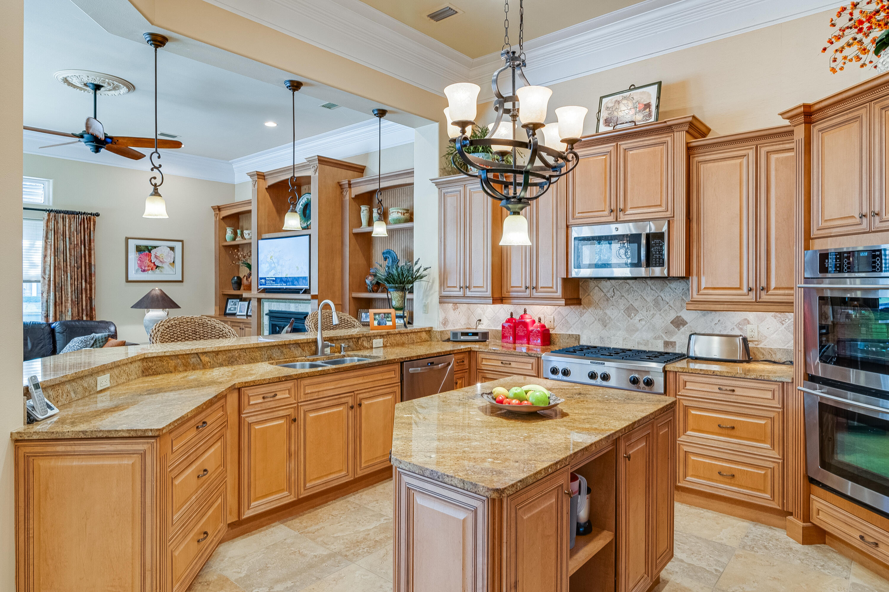 473 Captains Circle Destin, FL 32541 - Photo 27 of 64 a kitchen with kitchen island granite countertop a sink a counter space cabinets and appliances