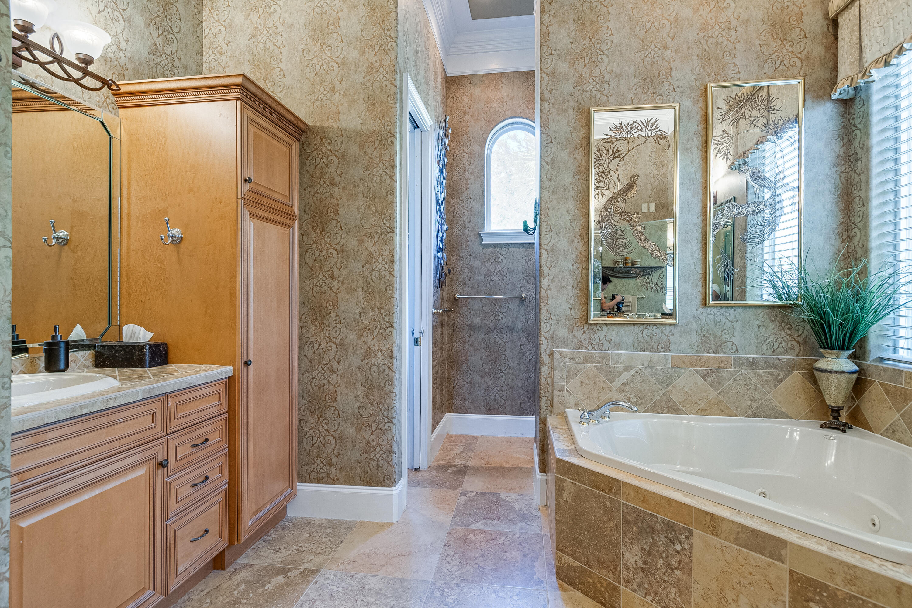 473 Captains Circle Destin, FL 32541 - Photo 52 of 64 a bathroom with a granite countertop bathtub shower sink and mirror