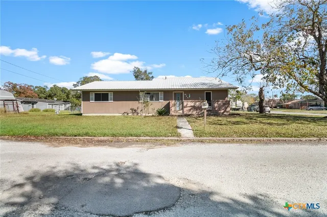 a view of house with yard and green space