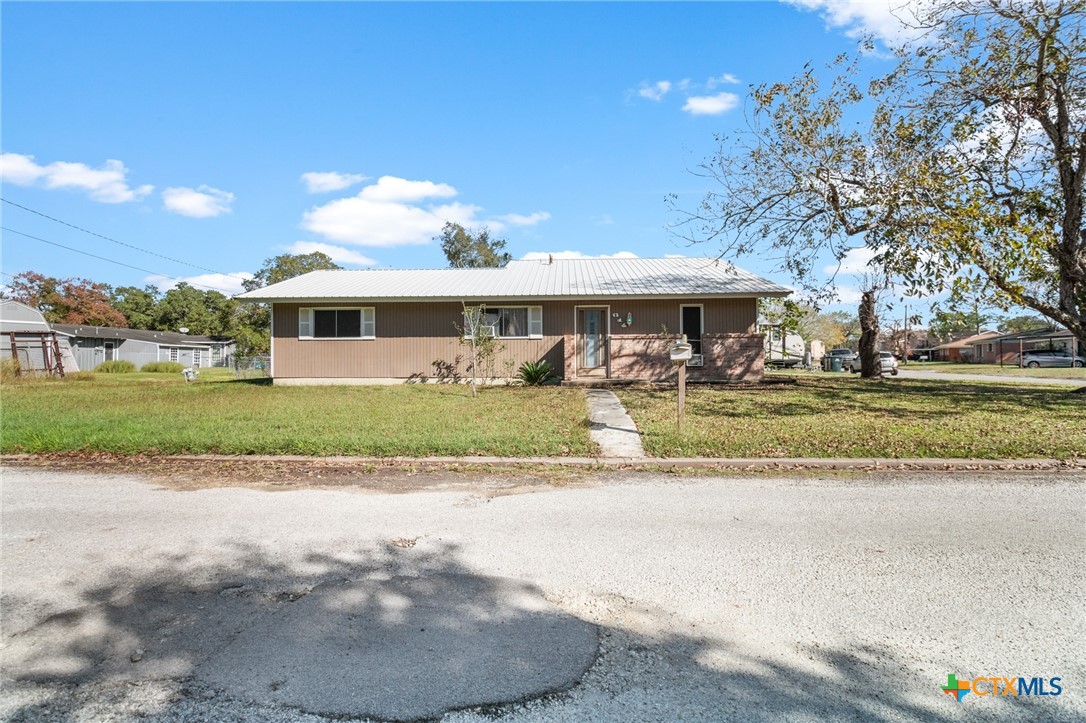 a view of house with yard and green space