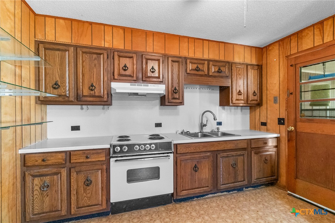 614 Sarah Street Edna, TX 77957 - Photo 11 of 19 a kitchen with stainless steel appliances granite countertop a sink and cabinets