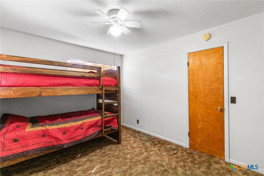 614 Sarah Street Edna, TX 77957 - Photo 15 of 19 a bedroom with a bed and a dresser