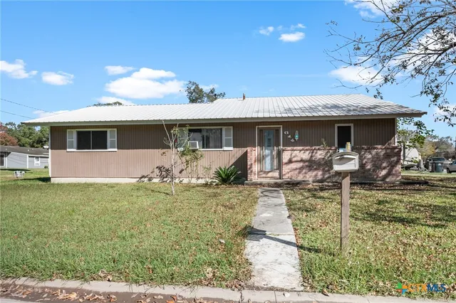 a front view of house with yard and furniture