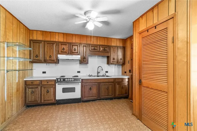 a kitchen with stainless steel appliances granite countertop a sink and cabinets