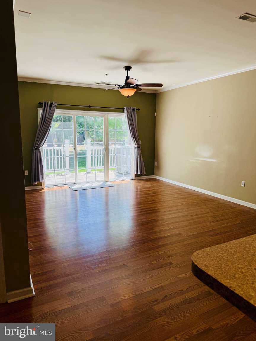 629 Ruxton Road, Unit 74 Solomons, MD 20629 - Photo 5 of 24 a view of a room with wooden floor and windows