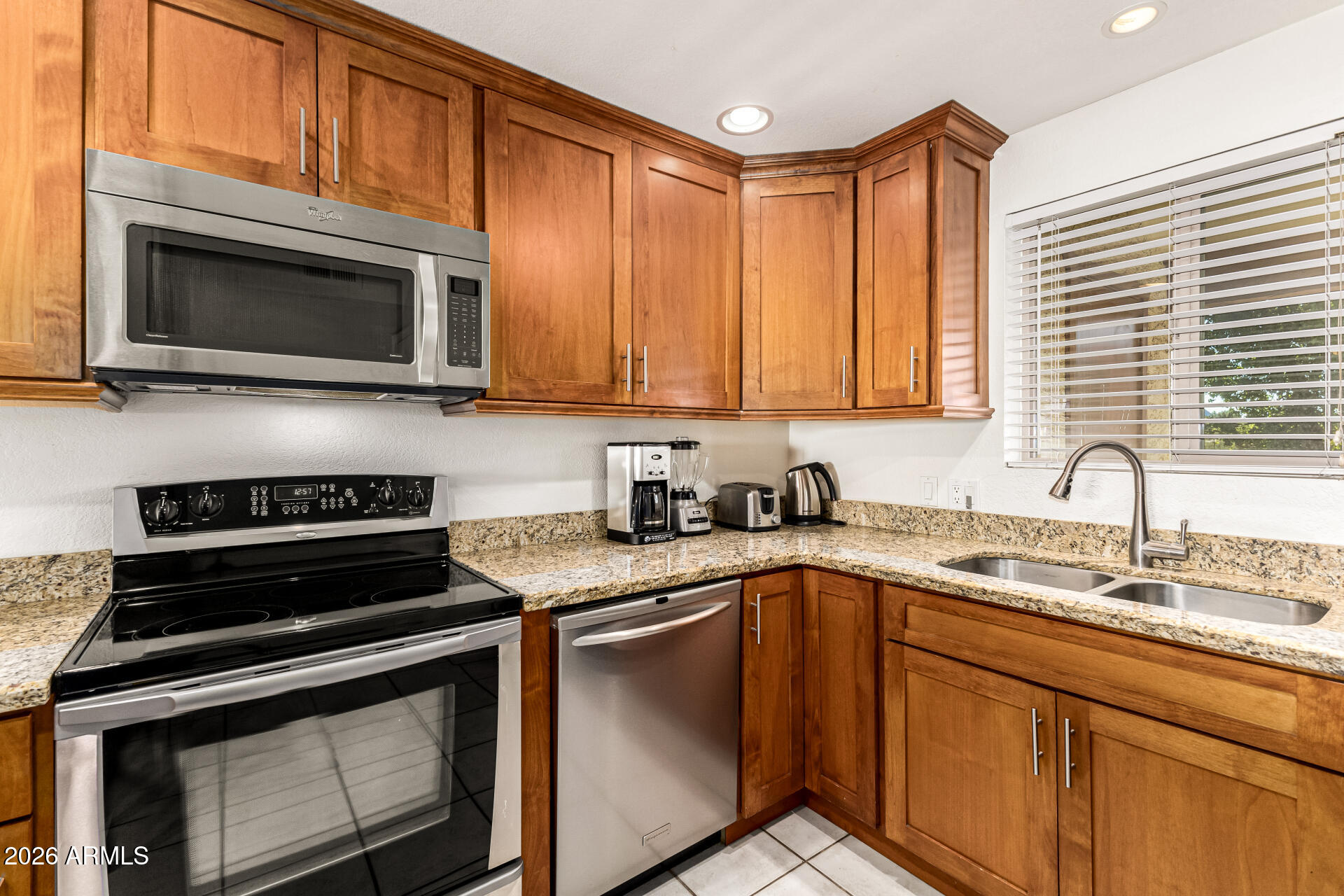 4150 East Cactus Road, Unit 210 Phoenix, AZ 85032 - Photo 19 of 45 a kitchen with a stove microwave and sink