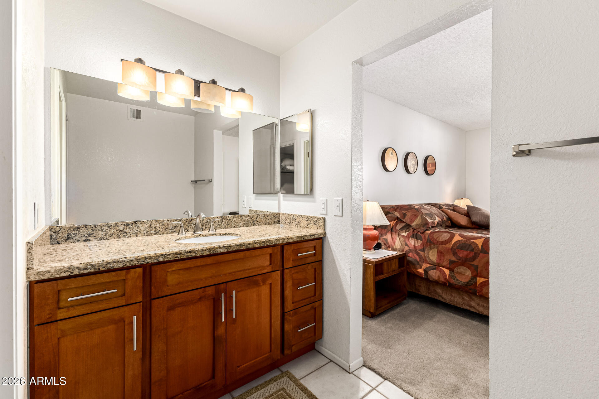 4150 East Cactus Road, Unit 210 Phoenix, AZ 85032 - Photo 24 of 45 a en suite bathroom with a double vanity sink and a mirror