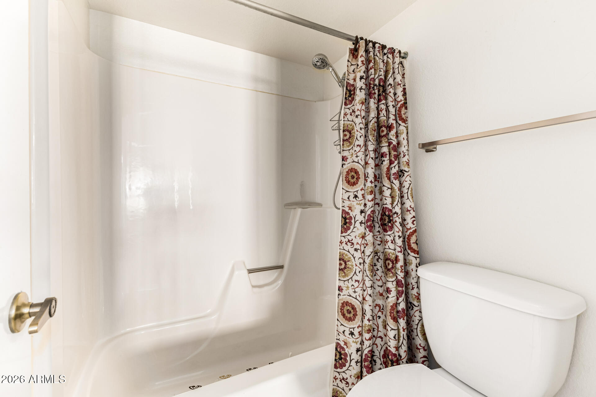 4150 East Cactus Road, Unit 210 Phoenix, AZ 85032 - Photo 25 of 45 a bathroom with a toilet and shower curtain