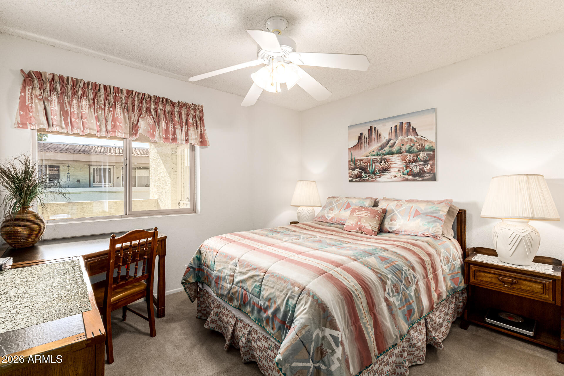 4150 East Cactus Road, Unit 210 Phoenix, AZ 85032 - Photo 27 of 45 a bedroom with a bed a couch and a large window