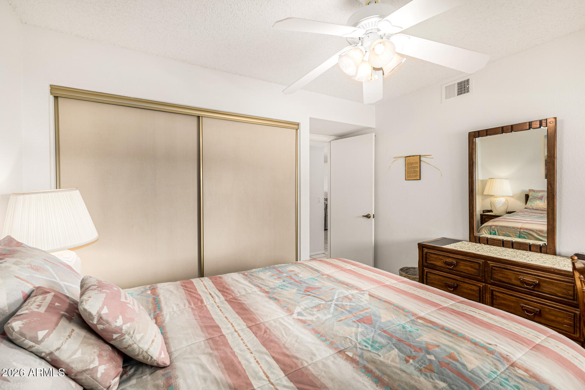 4150 East Cactus Road, Unit 210 Phoenix, AZ 85032 - Photo 29 of 45 a bedroom with a bed and a chandelier